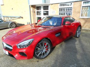 red sports car in car park